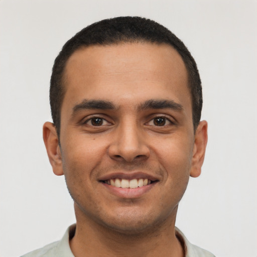 Joyful latino young-adult male with short  black hair and brown eyes