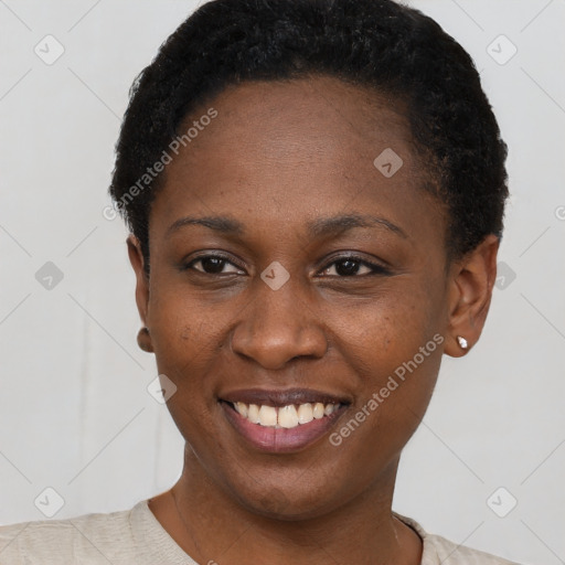 Joyful black young-adult female with short  black hair and brown eyes