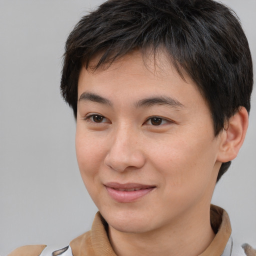 Joyful asian young-adult male with short  brown hair and brown eyes