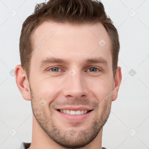 Joyful white young-adult male with short  brown hair and grey eyes