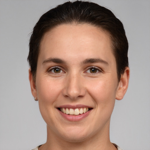 Joyful white young-adult female with short  brown hair and brown eyes