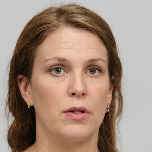 Neutral white adult female with long  brown hair and green eyes