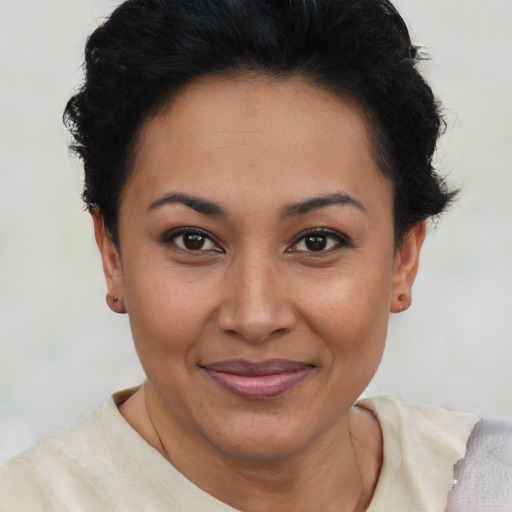 Joyful latino young-adult female with short  brown hair and brown eyes