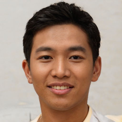 Joyful asian young-adult male with short  black hair and brown eyes