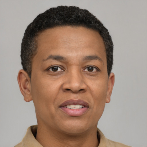 Joyful latino adult male with short  brown hair and brown eyes