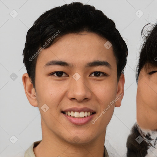 Joyful asian young-adult male with short  brown hair and brown eyes