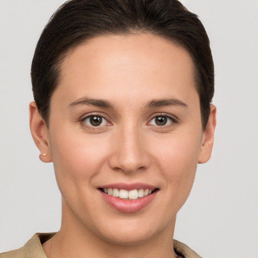 Joyful white young-adult female with short  brown hair and brown eyes