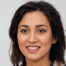 Joyful latino young-adult female with long  brown hair and brown eyes