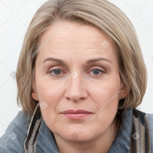 Joyful white adult female with medium  brown hair and blue eyes