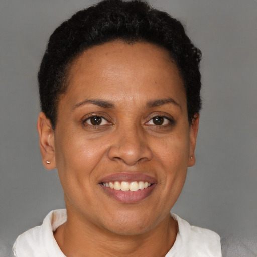 Joyful black adult female with short  brown hair and brown eyes