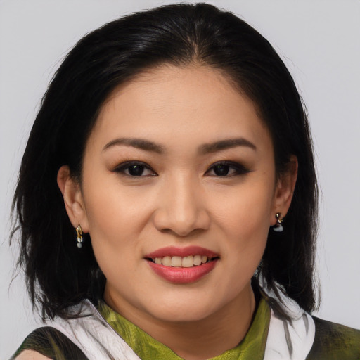 Joyful white young-adult female with medium  black hair and brown eyes