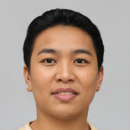 Joyful asian young-adult male with short  black hair and brown eyes