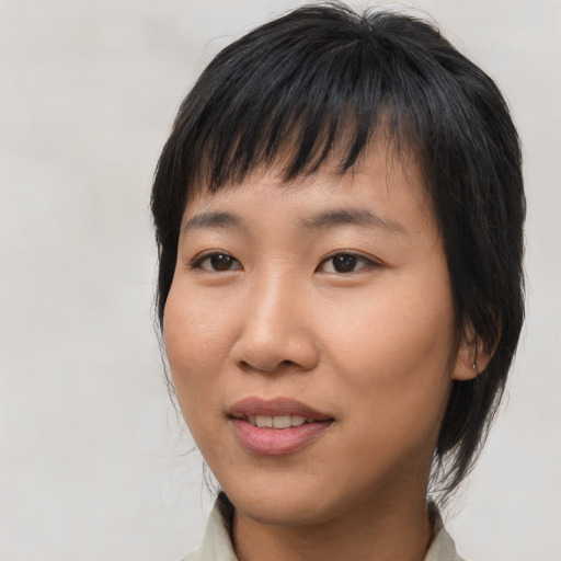 Joyful asian young-adult female with medium  brown hair and brown eyes