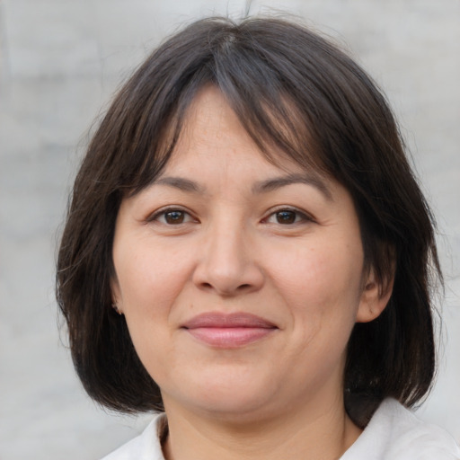 Joyful white adult female with medium  brown hair and brown eyes