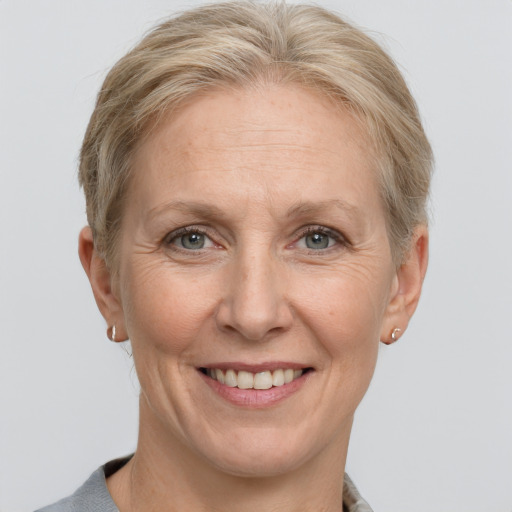 Joyful white middle-aged female with short  brown hair and grey eyes