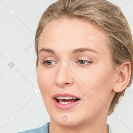 Joyful white young-adult female with medium  brown hair and blue eyes