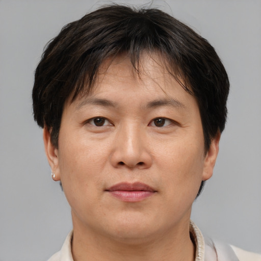 Joyful asian adult female with short  brown hair and brown eyes