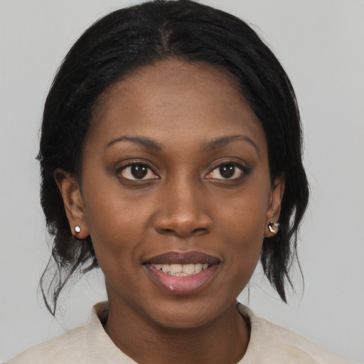 Joyful black young-adult female with medium  brown hair and brown eyes