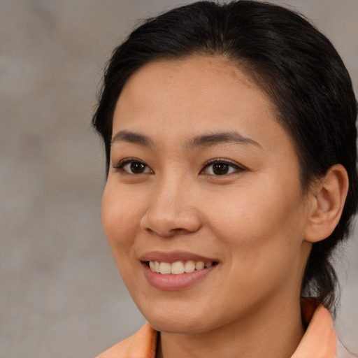 Joyful asian young-adult female with medium  brown hair and brown eyes