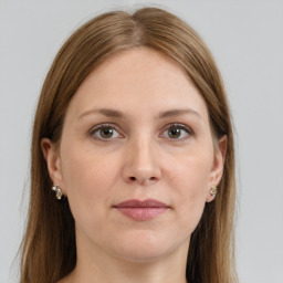 Joyful white young-adult female with long  brown hair and grey eyes