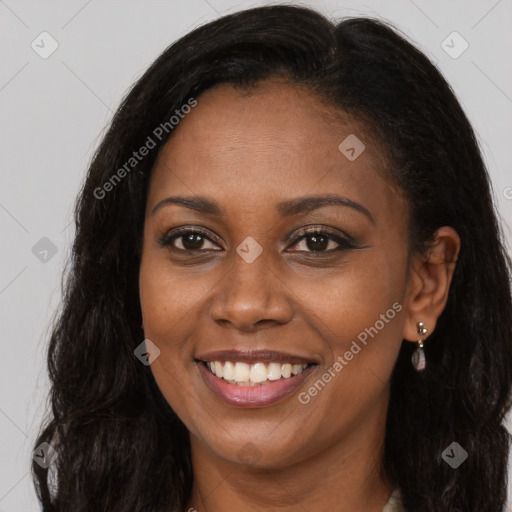 Joyful black young-adult female with long  brown hair and brown eyes