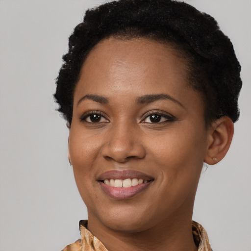 Joyful black young-adult female with short  brown hair and brown eyes