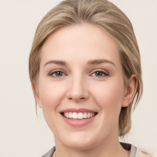 Joyful white young-adult female with medium  brown hair and blue eyes