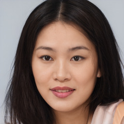 Joyful asian young-adult female with long  brown hair and brown eyes