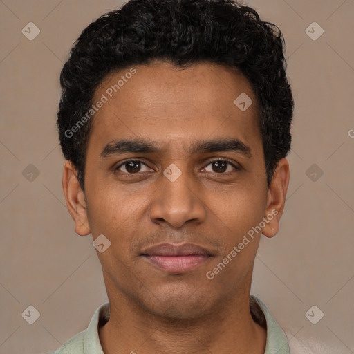 Joyful black young-adult male with short  black hair and brown eyes