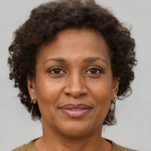 Joyful black adult female with short  brown hair and brown eyes