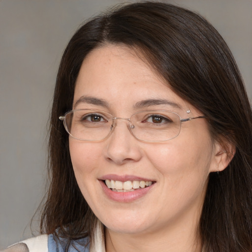 Joyful white adult female with medium  brown hair and brown eyes