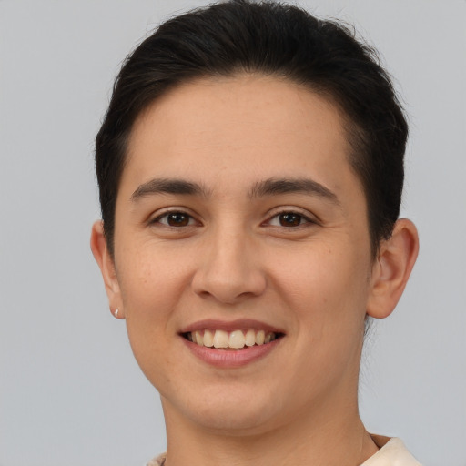 Joyful white young-adult female with short  brown hair and brown eyes