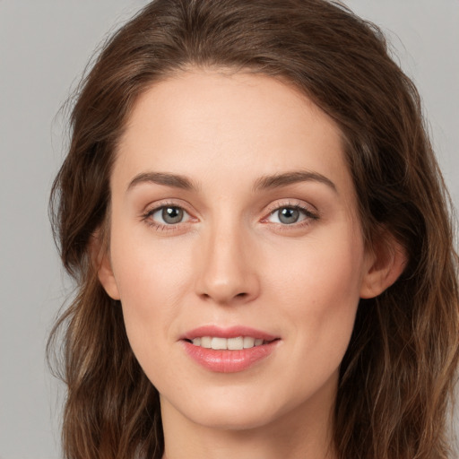 Joyful white young-adult female with long  brown hair and green eyes