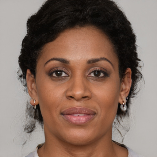 Joyful latino adult female with medium  brown hair and brown eyes
