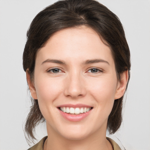 Joyful white young-adult female with medium  brown hair and brown eyes