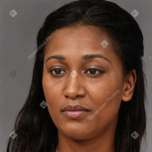 Joyful black young-adult female with long  brown hair and brown eyes