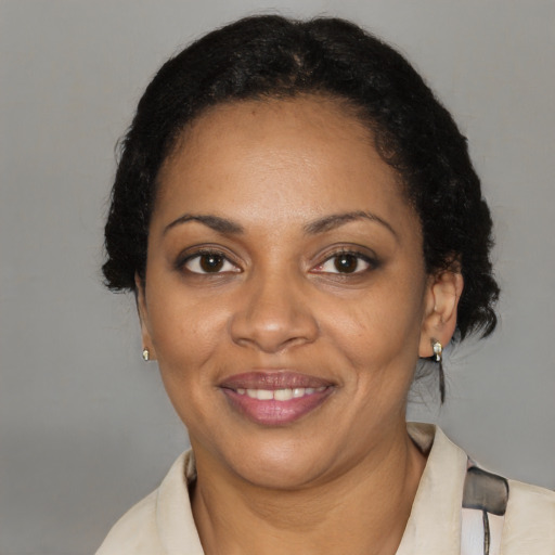 Joyful black adult female with short  black hair and brown eyes