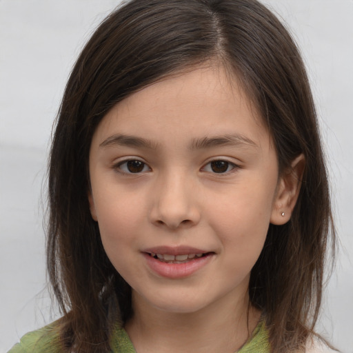 Joyful white child female with long  brown hair and brown eyes