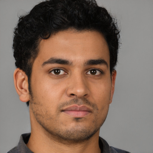 Neutral latino young-adult male with short  brown hair and brown eyes