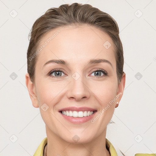 Joyful white young-adult female with short  brown hair and grey eyes