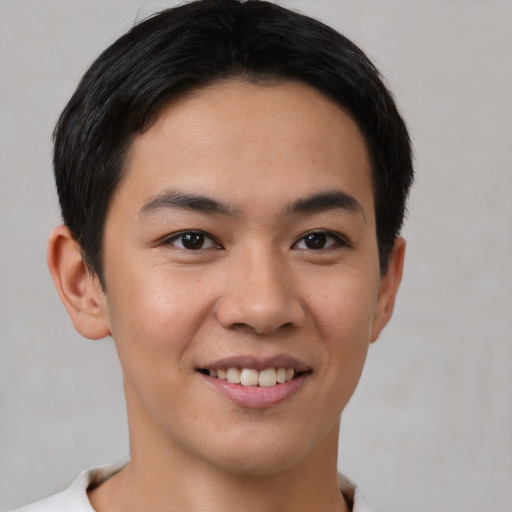 Joyful asian young-adult male with short  brown hair and brown eyes