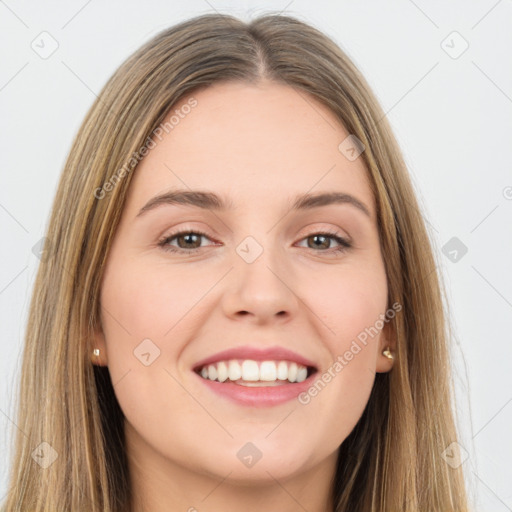 Joyful white young-adult female with long  brown hair and brown eyes