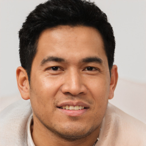 Joyful asian young-adult male with short  black hair and brown eyes