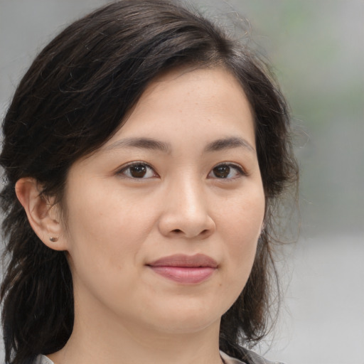 Joyful asian young-adult female with medium  brown hair and brown eyes
