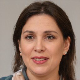 Joyful white adult female with medium  brown hair and brown eyes