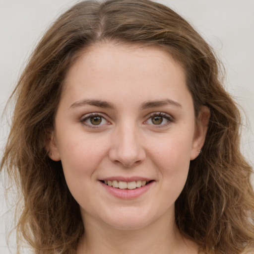 Joyful white young-adult female with long  brown hair and green eyes