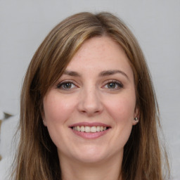 Joyful white young-adult female with long  brown hair and grey eyes