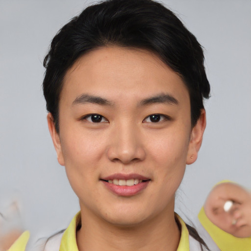 Joyful asian young-adult male with short  brown hair and brown eyes