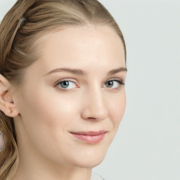 Joyful white young-adult female with long  brown hair and blue eyes