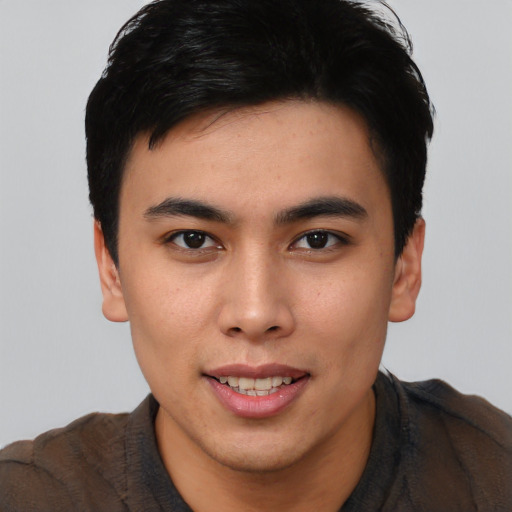 Joyful asian young-adult male with short  brown hair and brown eyes